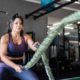 Mature woman working out with battle ropes at the gym